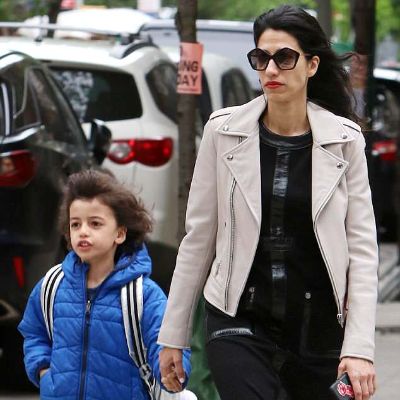 Huma Abedin is holding Jordan Zain Weiner's hand as they are walking.